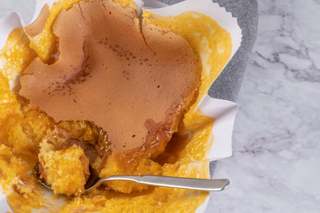 Portuguese sponge cake wrapped in the typical paper used on the baking, on marble backgroundの写真素材