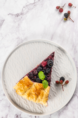 Slice of blackberries pie. Pie in summer with fresh picked wild blackberries. Top view.の写真素材