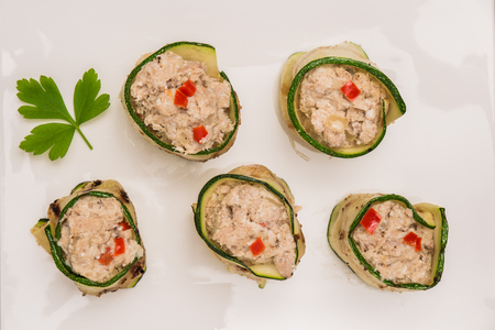 Grilled zucchini rolls with curd cheese and tuna on plate. Top view with copy spaceの写真素材