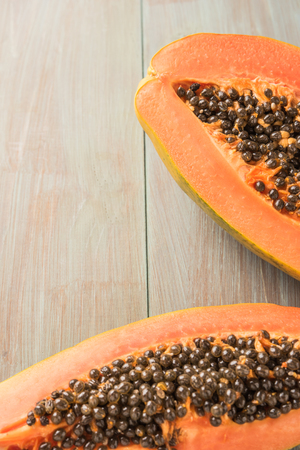 Sliced fresh papaya on wooden background. Top view with copy spaceの写真素材