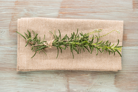 Bunch of fresh of garden rosemary on wooden table, rustic style, fresh organic herbs. Top view with copy spaceの写真素材