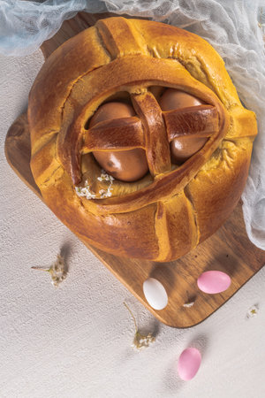 Portuguese traditional Easter cake. Folar with eggs on wooden table