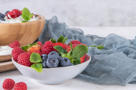 Yogurt and berries for healthy breakfast. Bowl of greek yogurt with raspberry, blueberries and...