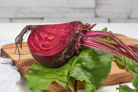 Organic beetroot vegetable / fresh red beet root harvested on wooden boardの写真素材