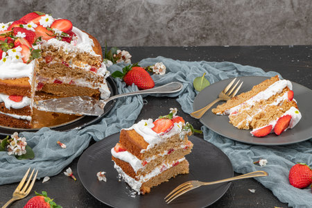 Strawberry cake, strawberry sponge cake with fresh strawberries and sour cream on a dark background