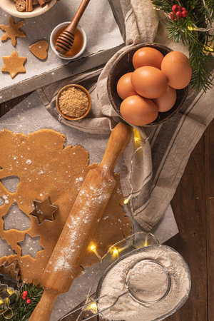 Making christmas gingerbread cookies. Raw dough in shape of gingerbread man, christmas tree, star,...
