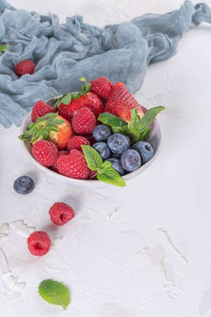 Yogurt and berries for healthy breakfast. Bowl of greek yogurt with raspberry, blueberries and strawberriesの写真素材