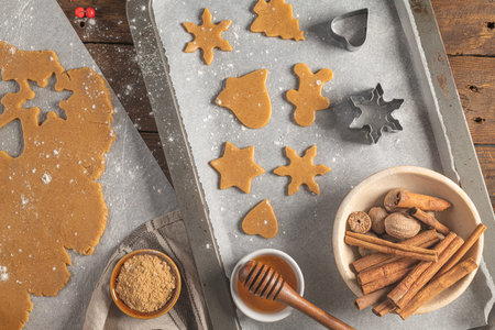 Making christmas gingerbread cookies. Raw dough in shape of gingerbread man, christmas tree, star,...