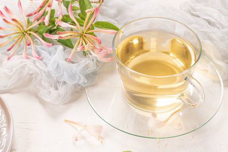 A cup of jasmine tea and jasmine flowers on a white background.の写真素材