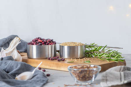 Raw white quinoa seeds (lat. Chenopodium quinoa), red beens, garlic and rosemary. Gluten free Healthy food. Diet, dieting conceptの写真素材
