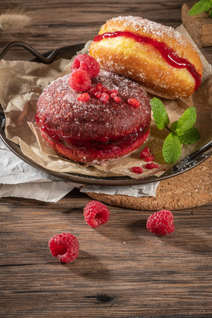 Bolas de Berlim, or Berlin Balls. Portuguese fried dough with sugar, Filled with chocolate or...
