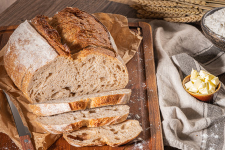 Freshly artisan baked wheat and rye bread, country bread. Simple bread  with butter for breackfastの写真素材