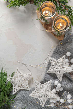 Holiday Christmas background with pine tree branches decorated gold Christmas lights, stars and candles. Christmas card background with festive decoration. Christmas holiday celebration, winter, New Yの写真素材