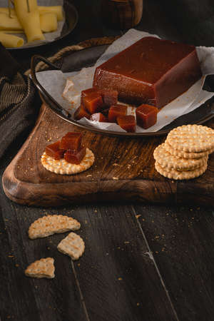 Quince cheese or marmelada is a sweet, thick jelly made of the pulp of the quince fruit. Marmalade in crackers on a kitchen counter. Dulce de membrillo in Spainの写真素材