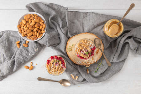 Breakfast oatmeal porridge with raspberries, almond, cinnamon, almond butter and coconut. Healthy breakfast delicious homemade english breakfast conceptの写真素材