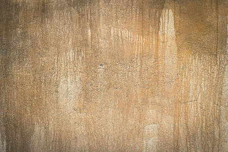 Old rough yellow cement wall surface Artistic. Walls and background, yellow concrete surface with the rough and scratched surfaceの写真素材
