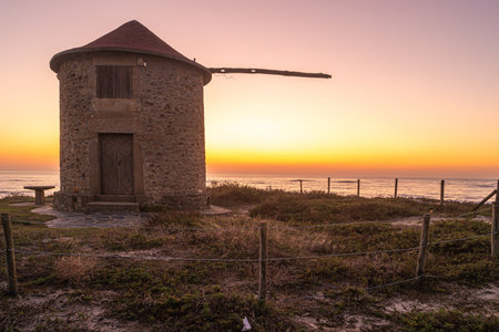 Old traditional wind-mills in sand-hills of Apulia Portugal
