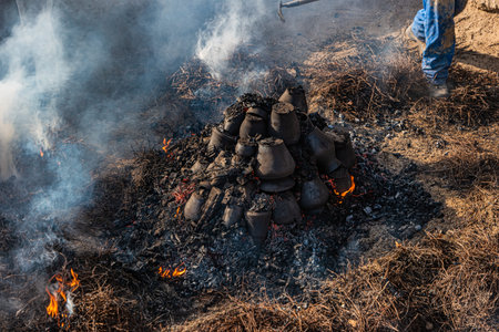 AMARANTE, PORTUGAL - CIRCA APRIL 2022: Final stage of uncovering the bonfire with the pieces of clay...