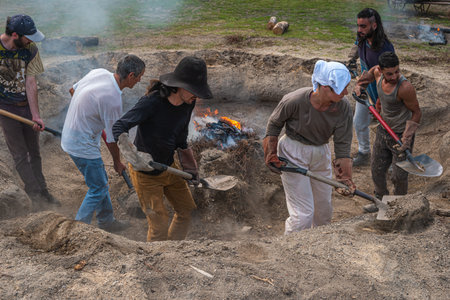 AMARANTE, PORTUGAL - CIRCA APRIL 2022: Stage of covering with soil of the bonfire with the pieces of...