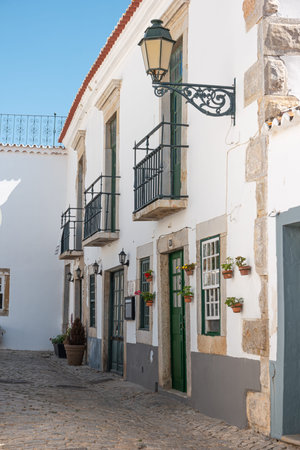 Small street in the old town of Faro in Algarve region, south of Portugal.
