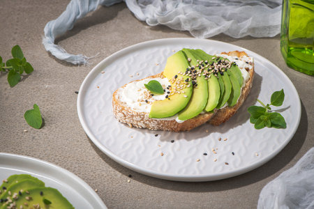 Healthy toast with avocado cream cheese and wheat bread on a plate. Delicious snacks and avocado...
