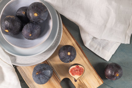 Fresh ripe figs on a wooden table. Healthy Mediterranean figs. Beautiful blue purple figs, selective...
