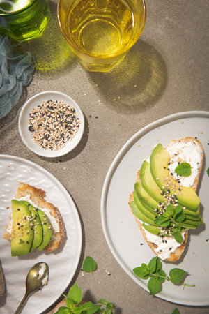 Healthy toast with avocado cream cheese and wheat bread on a plate. Delicious snacks and avocado sandwiches. Food composition, tasty Italian meal.の写真素材