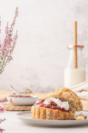 Traditional English pastries for afternoon tea: scones. Homemade raisin scones with clotted cream...