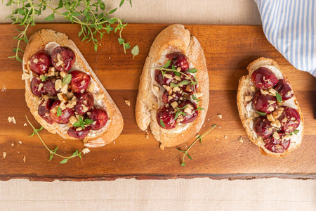 Toasts with goat cheese, grapes, nuts and honey.の写真素材