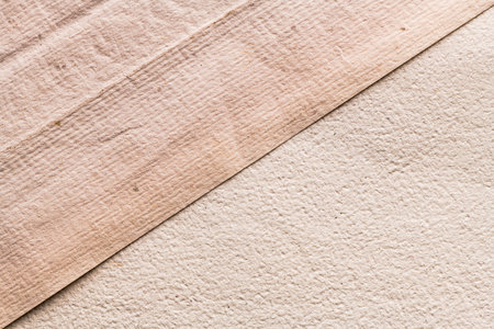 Recycled white and beige creased paper background or cardboard surface from a paper box for packing. For the designs decoration conceptの写真素材