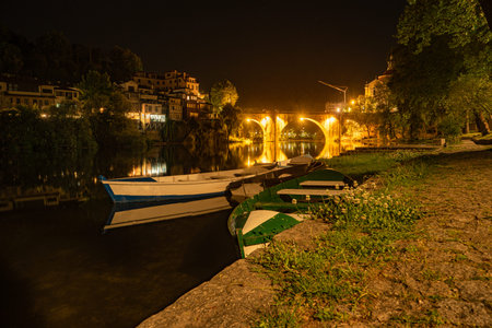 View at the Sao Goncalo monastery and the Old bridge over the river Tamega in Amarante at night -...