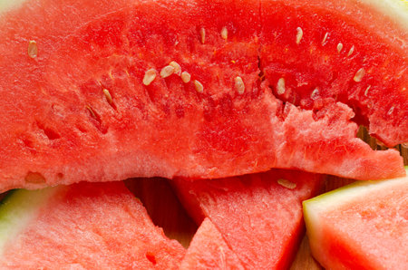 Slices of watermelon on a wood cutting board and wooden backgroundの写真素材