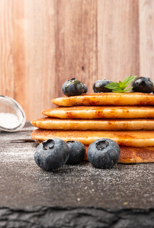 Stack of pancakes with fresh blueberry and caramel syrup