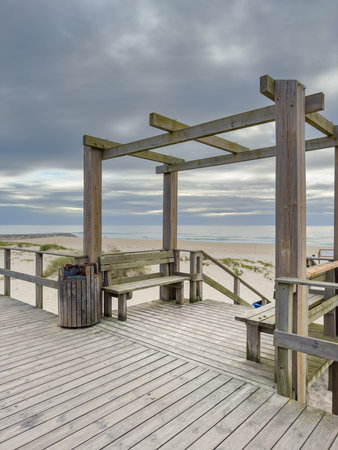 Seascape of wood walkways in Torreira beach during the sunset, Murtosa - Aveiro, Portugal