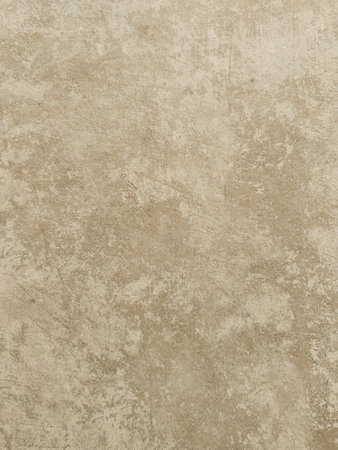 Detailed close-up of a textured light beige surface resembling aged concrete or plaster with subtle variations and marks, perfect for backgroundsの写真素材