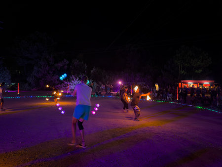 Ovar, Portugal - July 28, 2024: Jugglers of various nationalities practice fire juggling at nightのeditorial素材