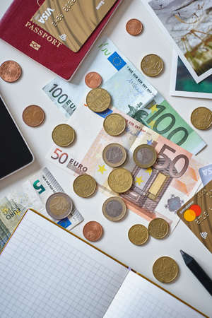 Moscow, Russia, Feb 29, 2020: Travel expenses concept. Fifty and one hundred Euro banknotes, coins, passport, Visa and Mastercard. Blank notebook for cost accounting with copy space for your textのeditorial素材