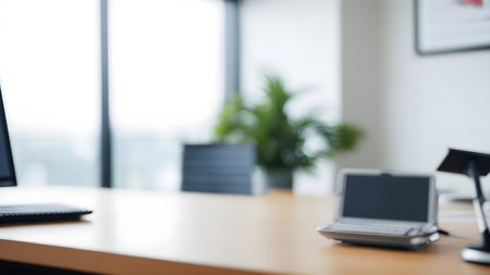 Blurred view of modern office workplace with laptop, tablet and smartphoneの素材