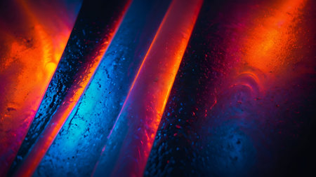 Abstract red, orange, and blue light streaks on dark backgroundの素材