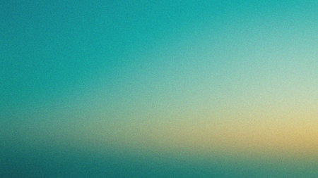 A vibrant abstract background featuring a gradient of teal and yellow hues with a mesmerizing texture creating a calming atmosphere and a sense of serenity and peacefulness.の素材