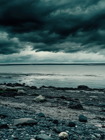 Dark Moody Seascape Dramatic Clouds Ocean Stones Beach Coastal sky grey blue calm view cold wildの素材