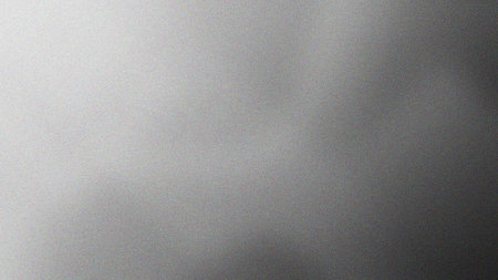A grainy texture background featuring a subtle gray gradient effect, ideal for adding depth and visual interest to designs, presentations, and digital projects.の素材