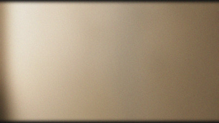 A high-quality, grainy beige background featuring a soft gradient and subtle vignette effect, perfect for design projects, wallpapers, and textures.の素材