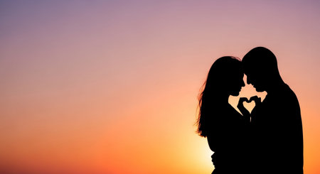 Silhouette of a loving couple on a background of the sunsetの素材