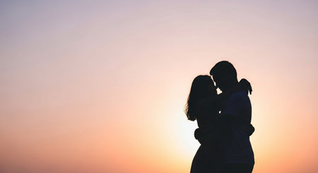 Silhouette of a loving couple against the background of the sunsetの素材