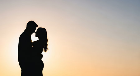 Silhouette of a loving couple against the sunset sky background.の素材