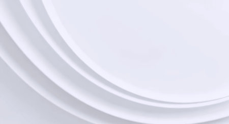 The image showcases a clean and minimalist design featuring smooth, flowing gradient curves on a white background. The curves are light grey and blend seamlessly, creating a subtle yet sophisticated visual effect. The simplicity of the design evokes a sense of calm and modernity, making it versatile for various uses such as backgrounds in digital media, branding materials, or abstract artistic compositions.の素材