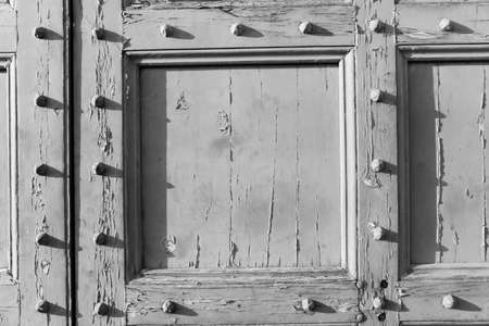 B & W antique wood door with studsの写真素材