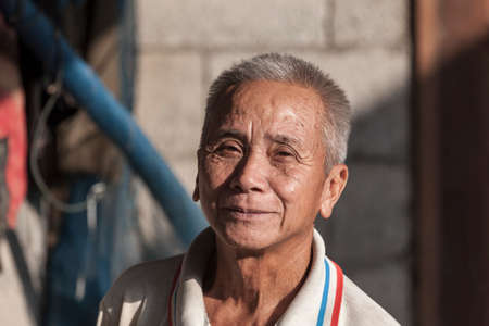 VANG VIENG, LAOS, JULY12, 2012: Portrait of a Laotian smiling uncle in the village of Vang Vieng in Laos.のeditorial素材