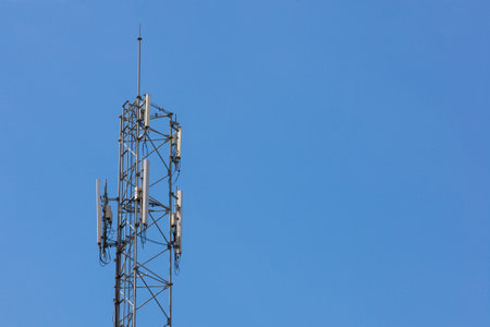 Telecommunication tower on blue sky for web background
